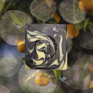 Citrus Midnight natural soap bar with deep charcoal and bright citrus tones, handcrafted with clays, botanicals, and essential oils.