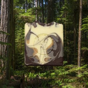 Stonepetal Rise natural soap bar with soft clay tones and charcoal accents, handcrafted with nourishing plant oils and a floral‑earth essential oil blend.