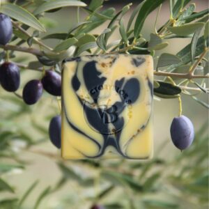 Geranium Smoke natural soap bar with deep charcoal and warm clay tones, handcrafted with floral, resinous essential oils and nourishing plant oils.